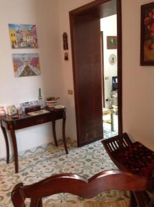 a living room with a chair and a table at Casa Valentino in Capri