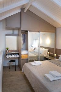 a bedroom with two beds with towels on them at Villa Pearl in Polykhrono