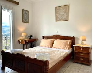 Un dormitorio con una cama grande y una ventana en Villa Serenity Spilia 1st floor, en Argostoli