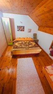 a large bed in a room with wooden floors at Apartments Lux Labovic in Kolašin