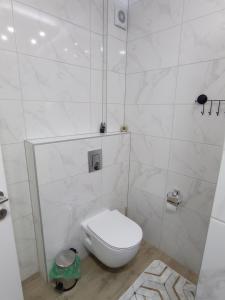 a white bathroom with a toilet in a room at STAN NA DAN BIJELJINA in Bijeljina