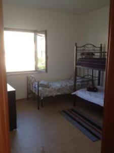 a room with two bunk beds and a window at Stignano Mare, near Caulonia, Calabria, Italy in Focà