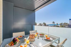 una mesa con comida y vistas al océano en Terraza al Mediterráneo, en Málaga