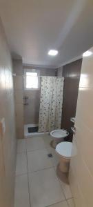 a bathroom with a toilet and a sink at Amplio departamento a estrenar ! in Godoy Cruz