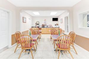 a dining room with chairs and a table at Super 8 Carrollton in Carrollton