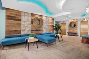 a lobby with blue furniture and wooden walls at Abitta Boutique Hotel, Ascend Hotel Collection in San Juan