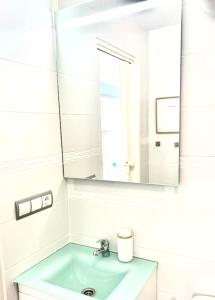a bathroom with a sink and a mirror at Apartamento Loft-Suite in Platja d'Aro