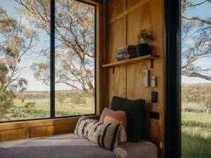 a room with a couch and large windows at CABN Clare Valley in Clare