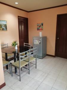 a dining room with a table and a refrigerator at Cranberry's place #3 in Iloilo City