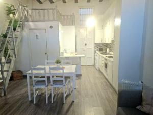 a kitchen and dining room with a table and chairs at Cabañal Home in Valencia