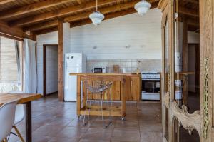 a kitchen with a counter and a refrigerator at BOG Dolce Far Niente in Villa La Angostura