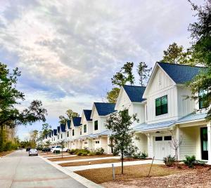 a row of white houses with blue roofs at Pink Sand Hideaway in Hilton Head Island