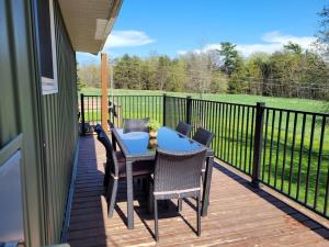 a patio with a table and chairs on a deck at Family friendly cottage ☆walking distance to beach in Lions Head