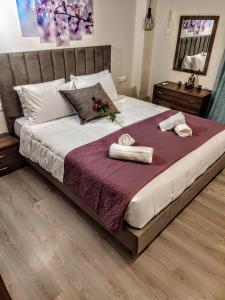 a bedroom with a large bed with towels on it at Blue Seaview Suites in Piraeus +94 photos
