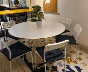 a white table and chairs with a potted plant on it at Big Groups Heaven in Central Location in Bangkok