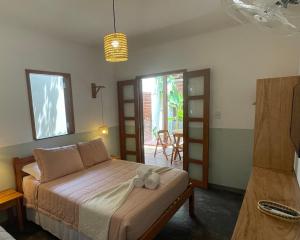 a bedroom with a bed with two towels on it at Recanto Alter do Chão in Alter do Chao