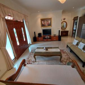 a living room with a couch and a coffee table at Villa D3 Bukit Cijulang in Bogor