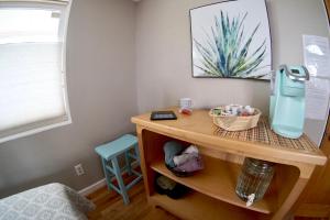 a childs room with a wooden table with a desk at Steps Away in Eugene