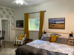 a bedroom with a bed and a window at Battle Creek Ranch, Wells Gray Park in Clearwater