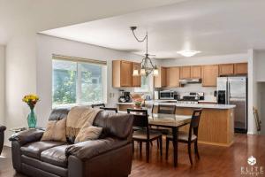 a living room with a couch and a table and a kitchen at Lavish 5 Star Modern Villa BEST Location in DOWNTOWN in Anchorage