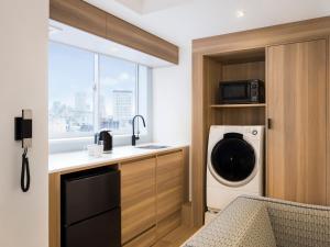 TV a/nebo společenská místnost v ubytování Tokyu Stay Shibuya Shin-Minamiguchi