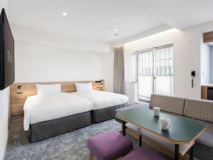 Postel nebo postele na pokoji v ubytování Tokyu Stay Shibuya Shin-Minamiguchi