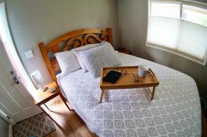 a bedroom with a large bed with a wooden table at Steps Away in Eugene