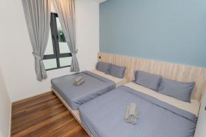 En eller flere senge i et værelse på Ipoh Tambun Lost World Sunway Onsen Suites Aria 2R2B 8 paxs