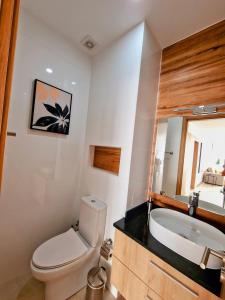 a bathroom with a toilet and a sink and a tub at Praia Modern Apartment vista Mar in Praia