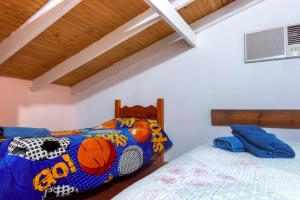 a bedroom with two beds with a basketball themed bedspread at Cabañas Mama Rosa in Puerto Iguazú +30 photos