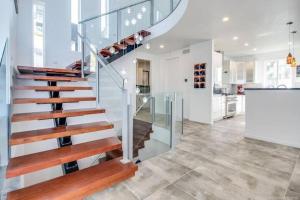 a staircase in a home with glass and wood at The Infiniti Villa in Kelowna