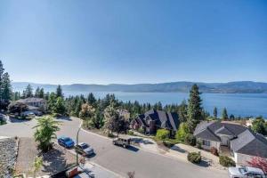 an aerial view of a house with a lake at The Infiniti Villa in Kelowna