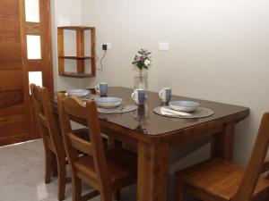 einem Holztisch mit Platten und Schalen darauf in der Unterkunft Casa Itabaca II in Puerto Ayora