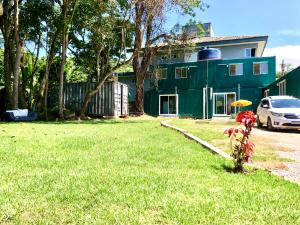 a bike parked in the grass in front of a house at Recanto Canajurê in Florianópolis