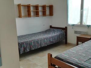 a room with two beds and a table and windows at Villa Moderne et Calme, Proche Plage, Centre-Ville, 6 Pers., Jardin, Tout Confort - FR-1-476-87 in La Faute-sur-Mer