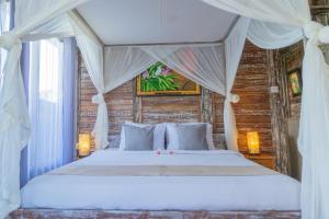 Postel nebo postele na pokoji v ubytování Ananda JJ Ubud Resort & Spa