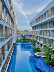a rainbow is seen from the side of a building at Arshika Bali Sunset Road in Kuta
