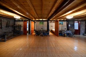 a large room with wooden floors and wooden ceilings at Sapa Fantasea Homestay in Sapa