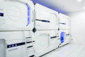 a row of white washing machines in a room at RedDoorz Hostel near Taman Puring in Jakarta