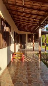 a bench sitting in the middle of a building at Casa de Praia 4qtos em Saquarema! in Saquarema