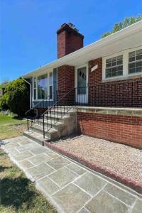 a brick house with a brick staircase leading to the front door at Spacious single family home close to VA and DC 5mins to MGM in Fort Washington