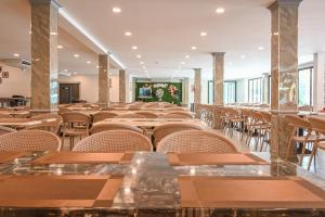 an empty restaurant with tables and chairs at Golden Sea Hua Hin - SHA Extra Plus in Hua Hin
