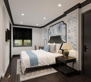 a bedroom with a bed with blue and white wallpaper at HƯỚNG DƯƠNG HOTEL THANH HOÁ in Thanh Hóa