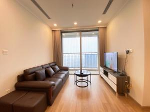 a living room with a leather couch and a television at Vinhomes Gardenia 16 Hàm Nghi,Mỹ Đình,Nam Từ Liêm in Hanoi