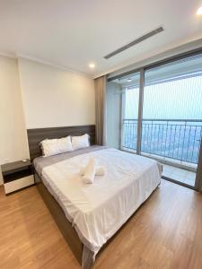 a bedroom with a large bed with a large window at Vinhomes Gardenia 16 Hàm Nghi,Mỹ Đình,Nam Từ Liêm in Hanoi +13 photos