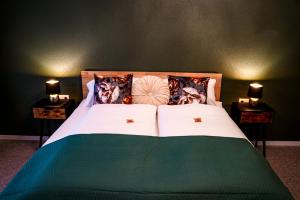 a bedroom with a bed with two night stands at Hotel-Residenz-Luxury-Apartments in Metzingen
