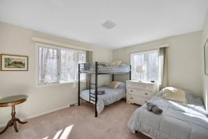 a bedroom with two bunk beds and a desk at Pocono Pines, Lake Naomi 4 bedrooms, 2 full bath in Pocono Pines