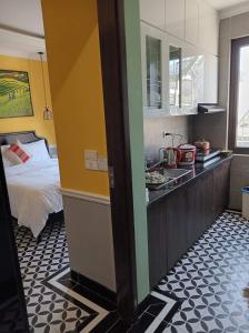 a bedroom with a bed and a kitchen with a sink at Sapa Tay Bac Home in Sa Pa