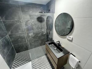 a bathroom with a sink and a mirror at בוטיק רפאל Boutique Rafael in Eilat +46 photos