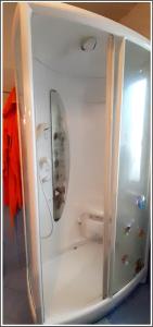 a refrigerator with a surfboard sticking out of it at STANZA ORO bagno con doccia idromassaggio in Udine